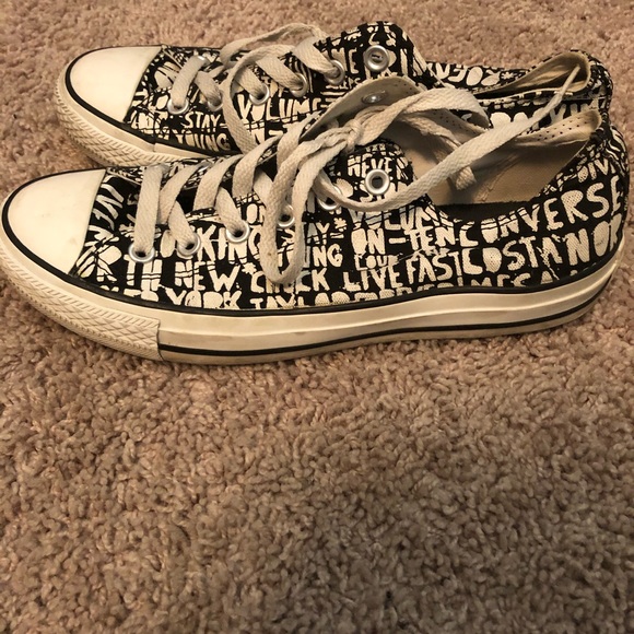 white converse with black writing